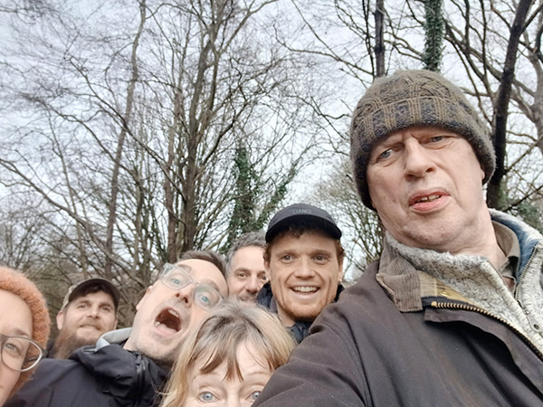 A selfie of a group of volunteers, pulling happy faces