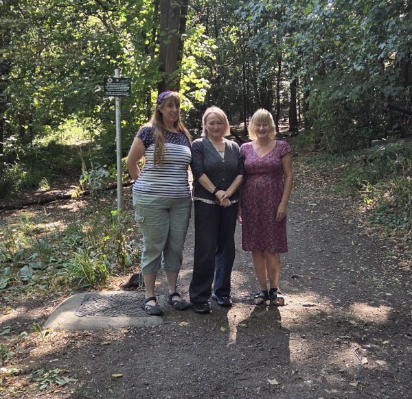 Three people stand in woodland - MP Kerry McCarthy, Councillor Katja Hornchen and Jackie Friel.